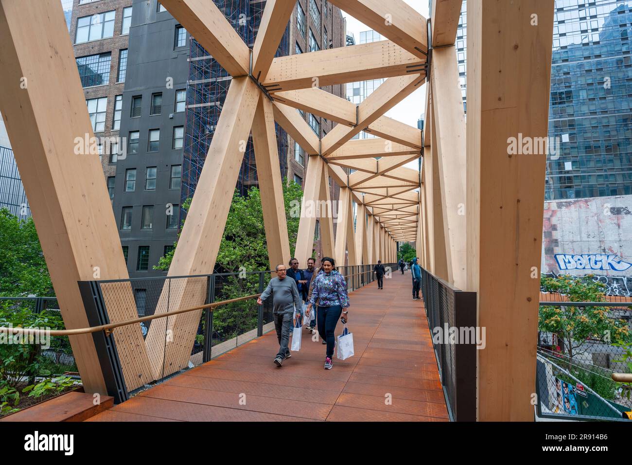 Visitors traverse the High Line-Moynihan Connector in the Hudson Yards neighborhood on opening day, Thursday, June 22, 2023. The timber bridge and the accompanying woodland bridge connect the High Line extension to Brookfield’s Manhattan West plaza enabling an almost traffic free walk to the Moynihan Train Hall. (© Richard B. Levine) Stock Photo