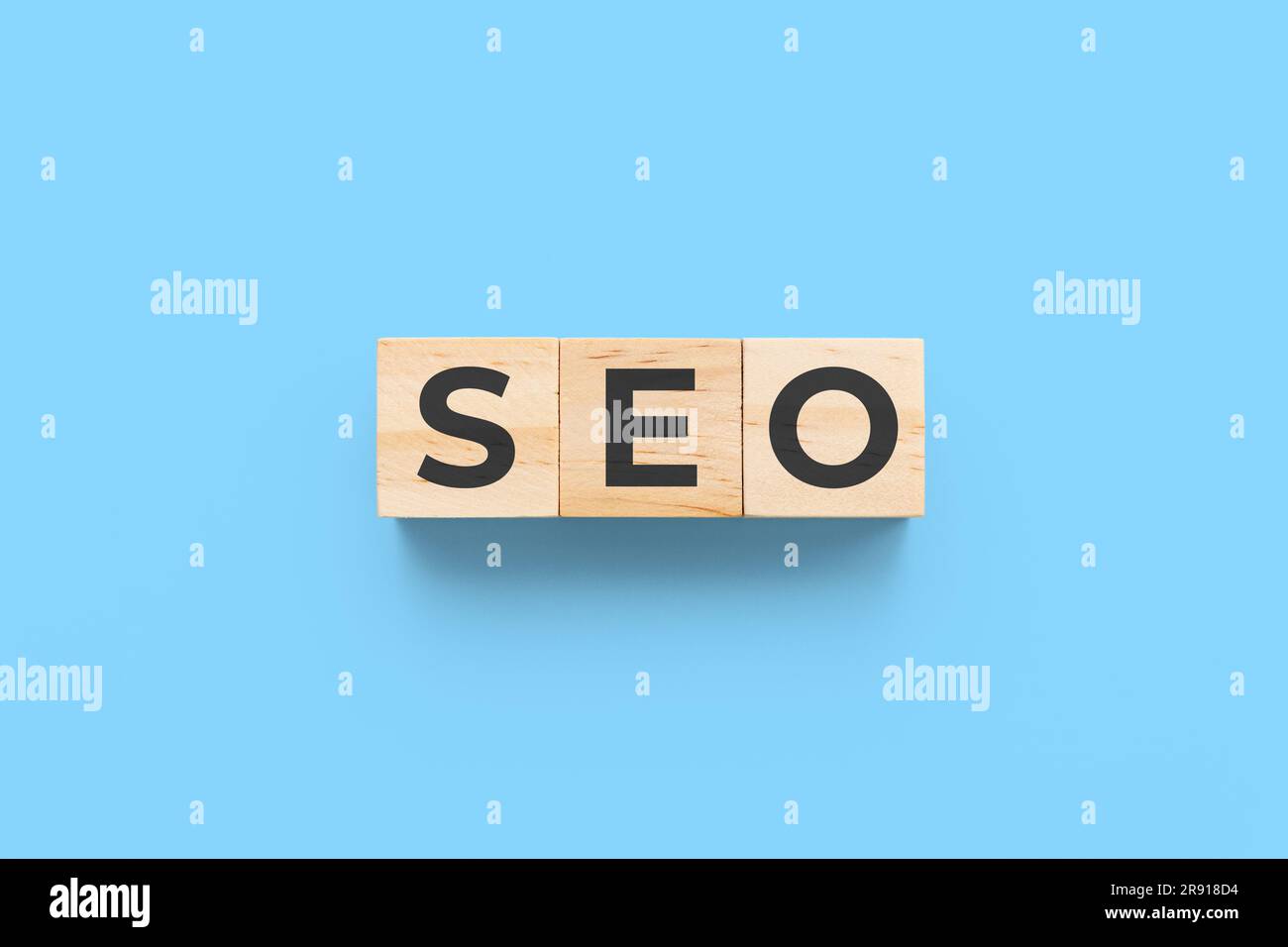 SEO (search engine optimization) wooden cubes on blue background Stock Photo