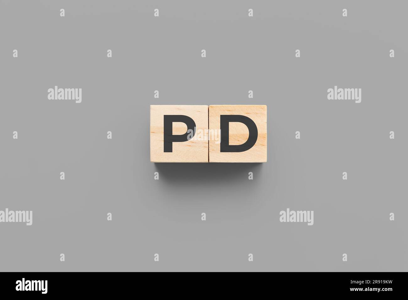 PD (Parkinson’s Disease) wooden cubes on grey background Stock Photo