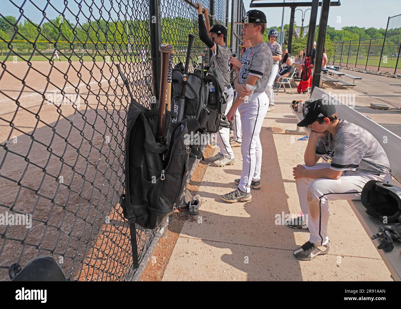 Benched 13-yr-old baseball player looking depressed. Stock Photo