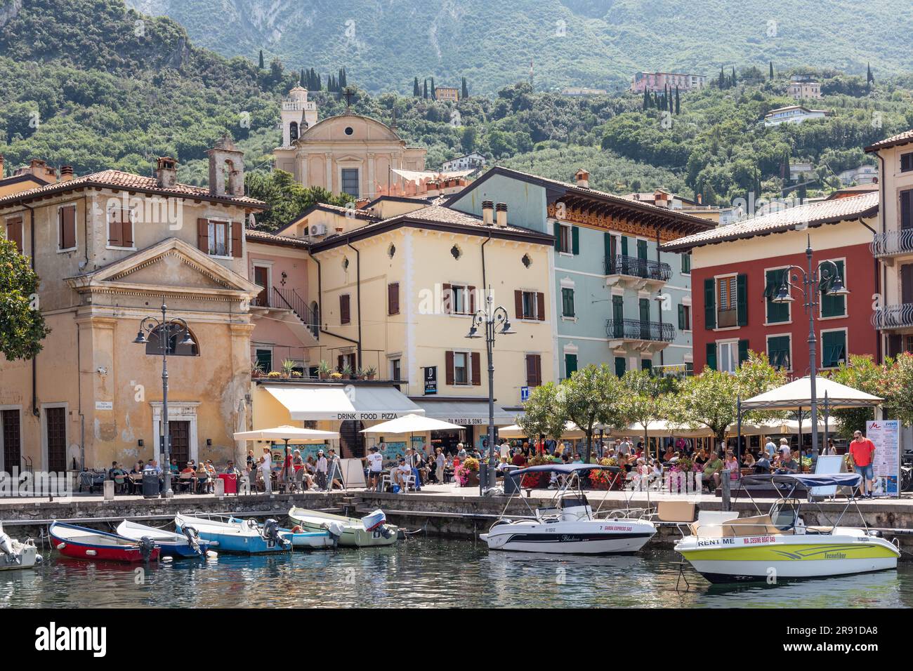 The picturesque port Malcesine in Piazza Guglielmo Marconi which is surrounded by many restaurants and cafes, Malcesine, Lake Garda, Italy, Europe Stock Photo