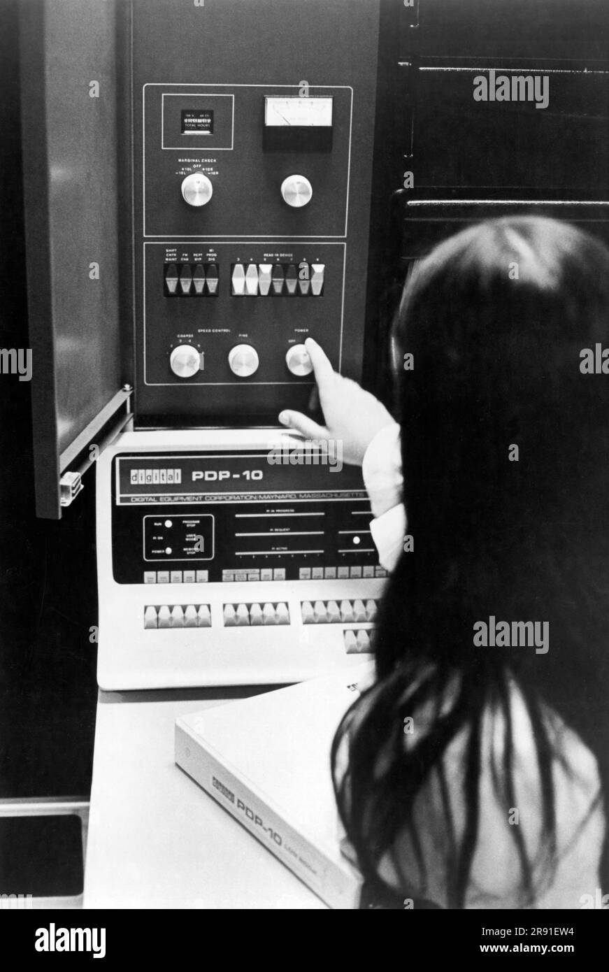 Princeton, New Jersey:  1969 A woman adjusting an Applied Logic Corporation (AL/COM) time sharing AL-10  computer system. which consists of two Digital Equipment Corporation (DEC) PDP-10 central processing units linked together. Stock Photo