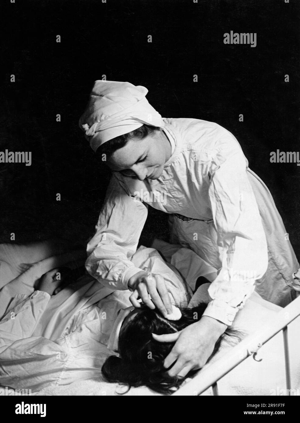 Nurse bending Black and White Stock Photos & Images - Alamy