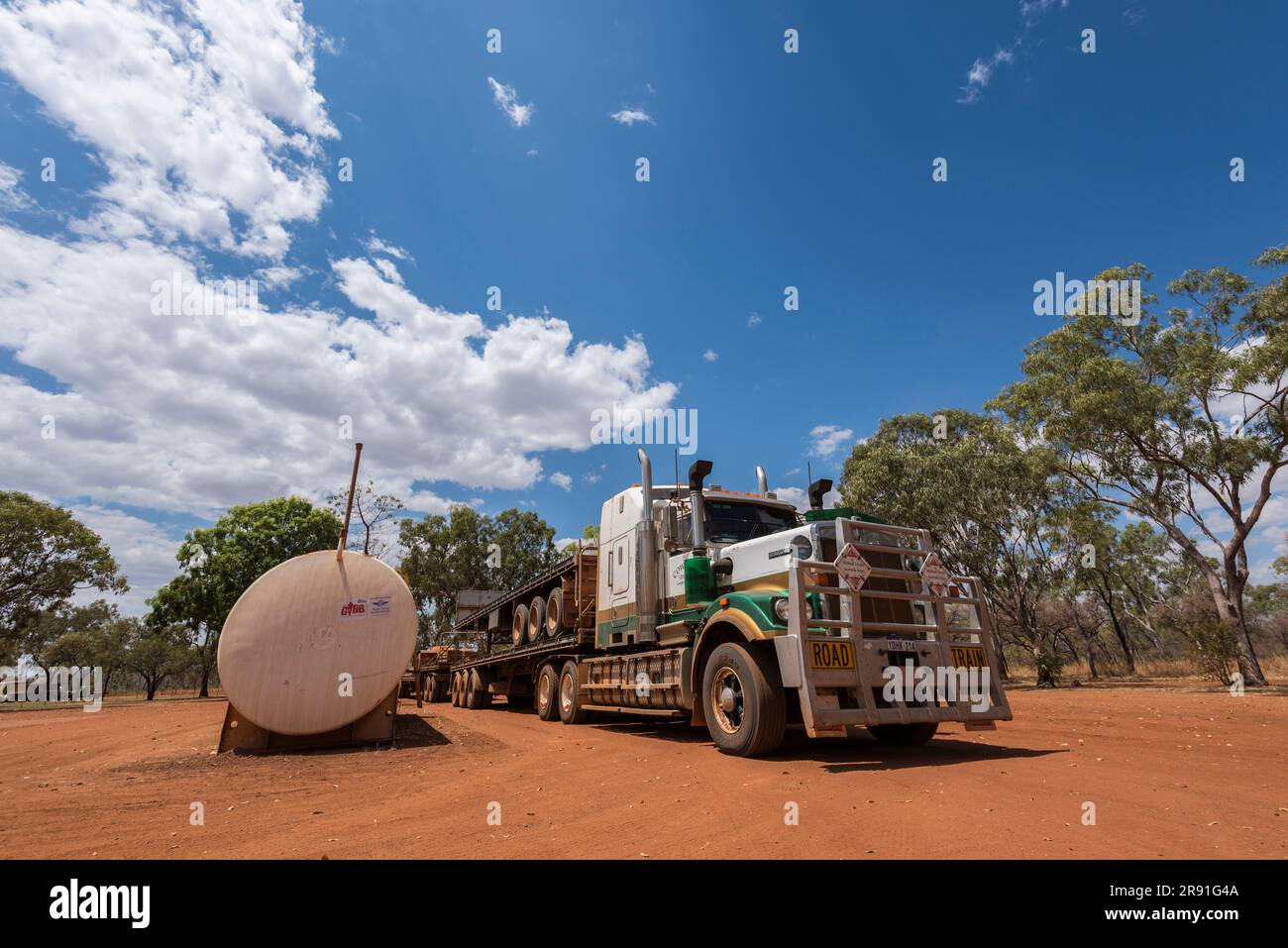 A road train waits on the red soil at the road house in Mount Barnett in Western Australia Stock Photo
