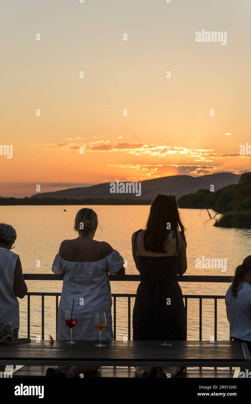 People enjoying drinks and enjoying the sunset over the dam in Kununurra Western Australia Stock Photo