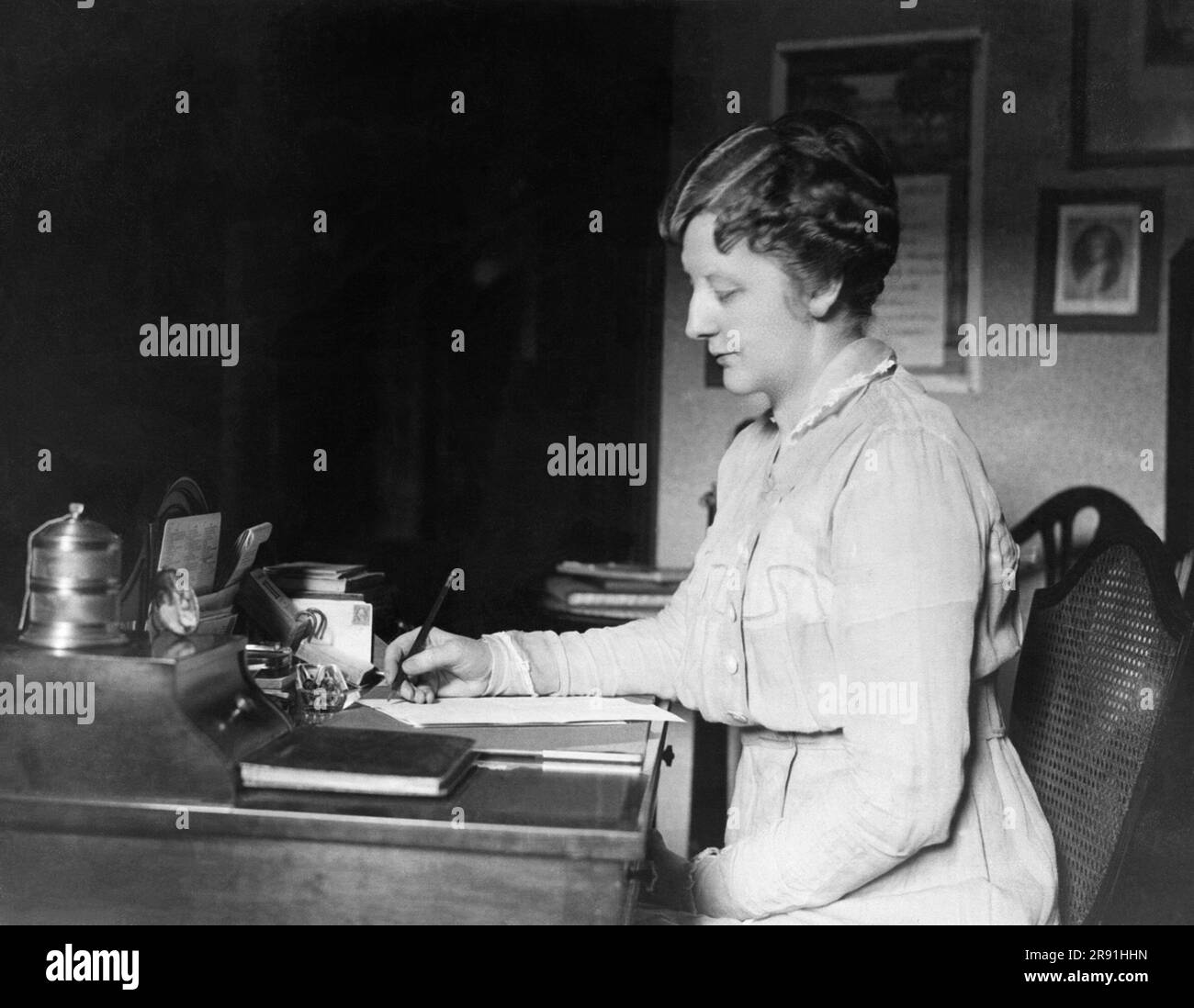 New York, New York:   c. 1922 A woman writing at her desk at the Hotel McAlpin in New York City. Stock Photo