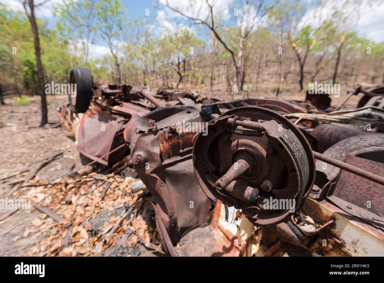 An old rusty wreck of an abandoned car is left in the Australian outback in the hot sun Stock Photo