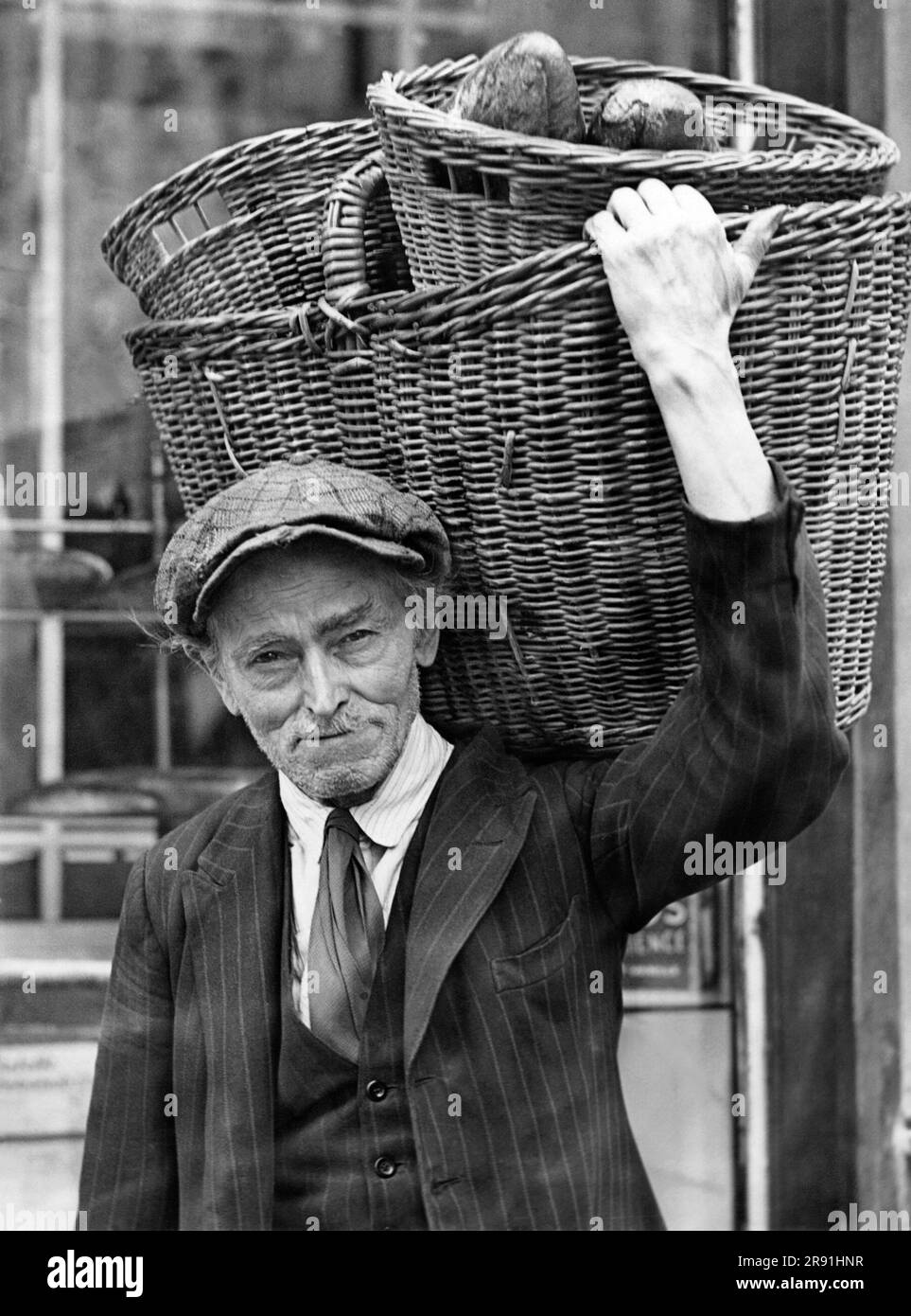 Germany:  c. 1916 A 73 year old man celebrates his 50th anniversary of delivering bread from the baskets he carries on his shoulder. Stock Photo