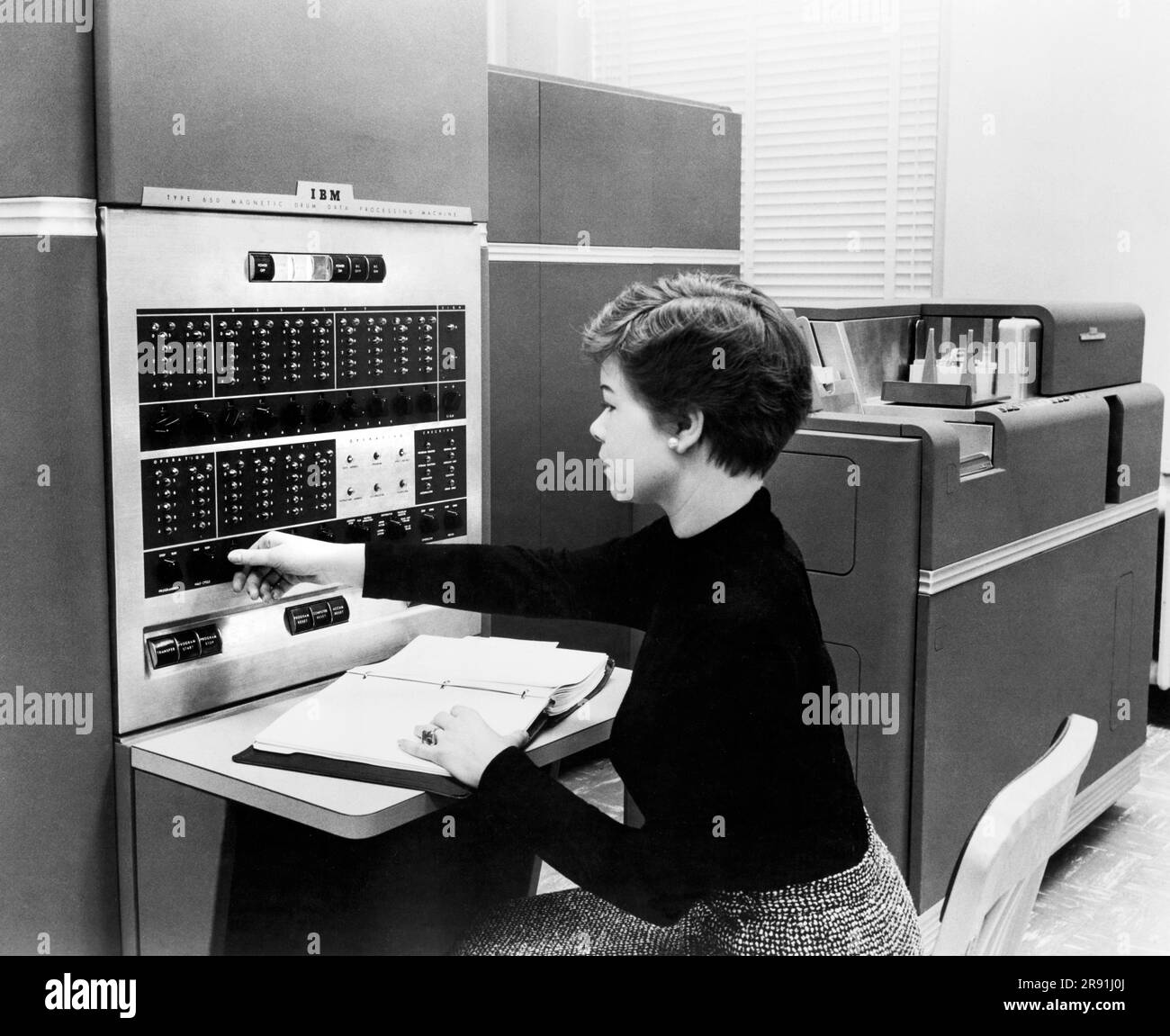 New York:  1954. IBM 650 Data Processing System, the first mass produced computer. IBM sold 450 of them the first year. Acessories include up to 4 disk units, each holding 6 Mb of data.. Stock Photo