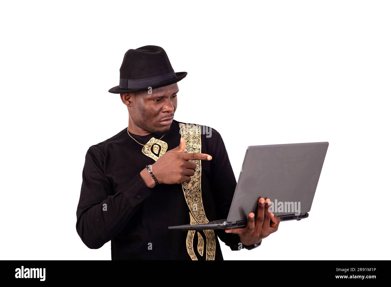 well-dressed young man pointing finger at laptop screen. Stock Photo