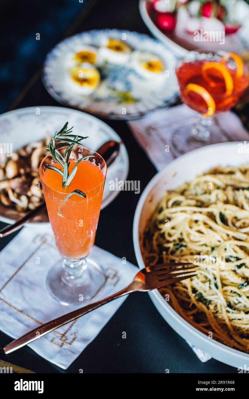 red and orange cocktails on table at spring, summer dinner party Stock Photo