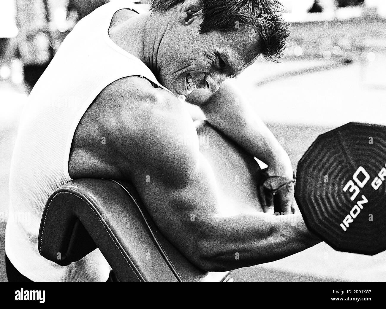 Palm Springs, California, USA. 16th Apr, 2009. Bodybuilder Jake Sawyer doing standing one arm preacher bench curls in the gym. (Credit Image: © Ian L. Sitren/ZUMA Press Wire) EDITORIAL USAGE ONLY! Not for Commercial USAGE! Stock Photo