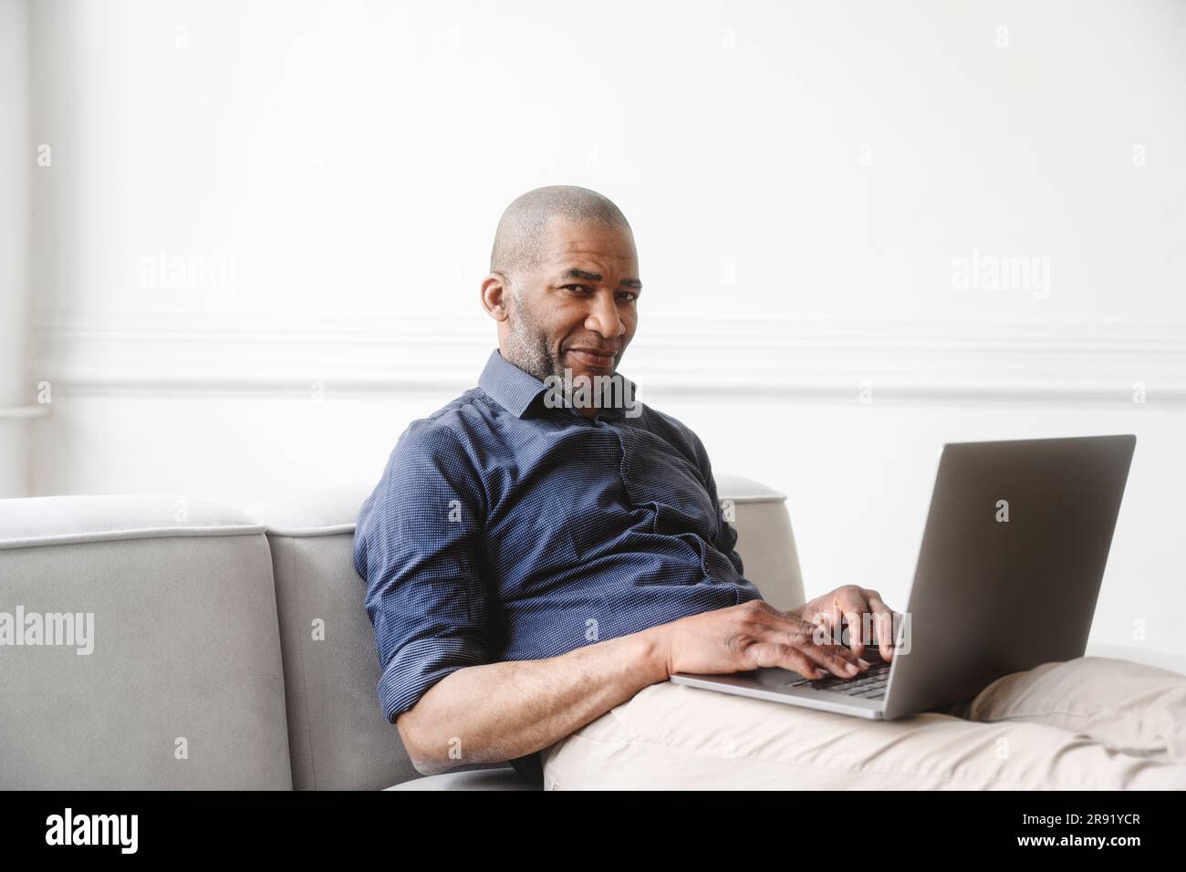 Businessman working on laptop at home Stock Photo