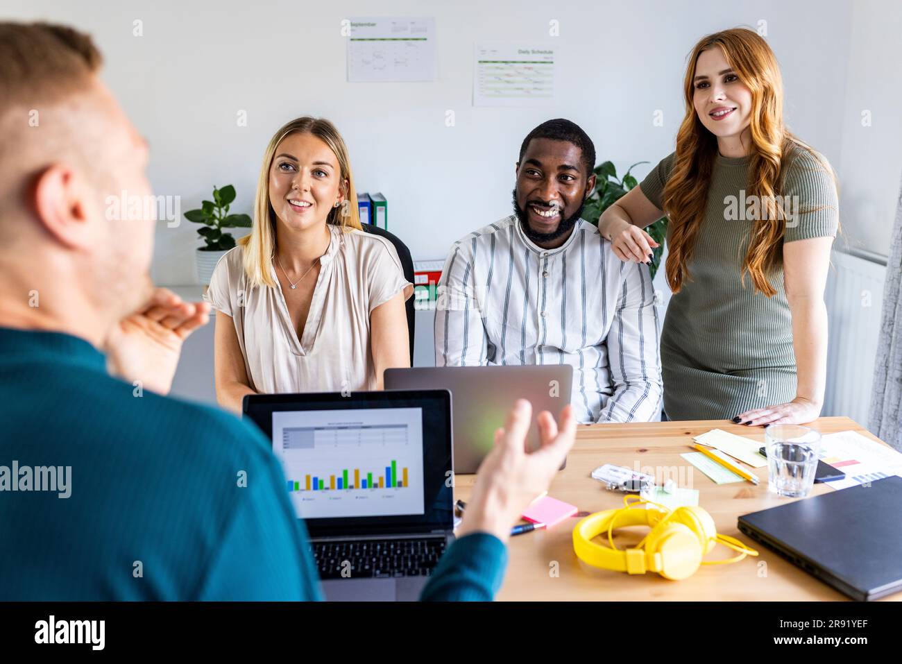 Businessman discussing with multiracial colleagues in meeting at office ...