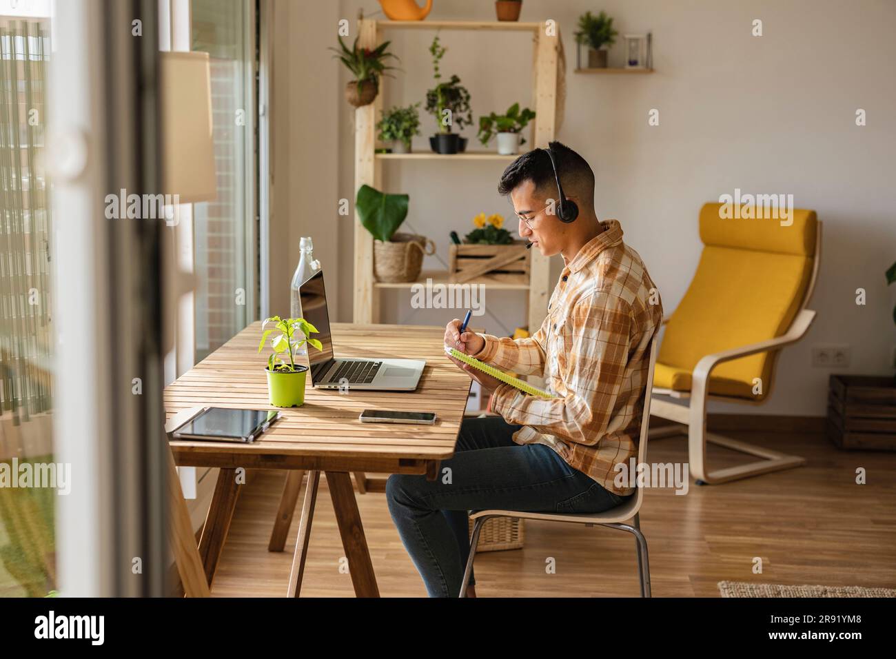 Freelancer man wearing headset and working at home office Stock Photo