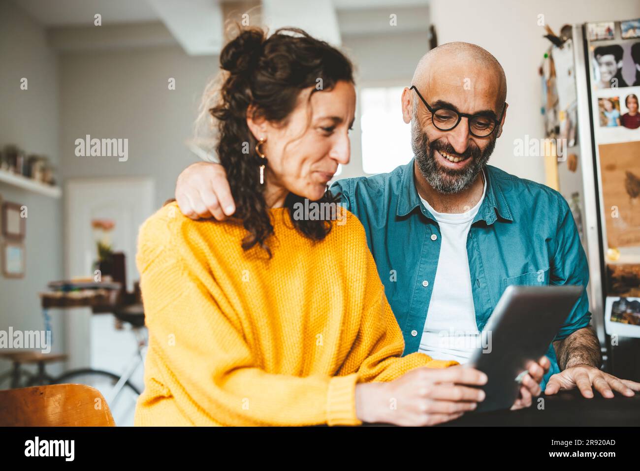 Happy couple using tablet PC at home Stock Photo