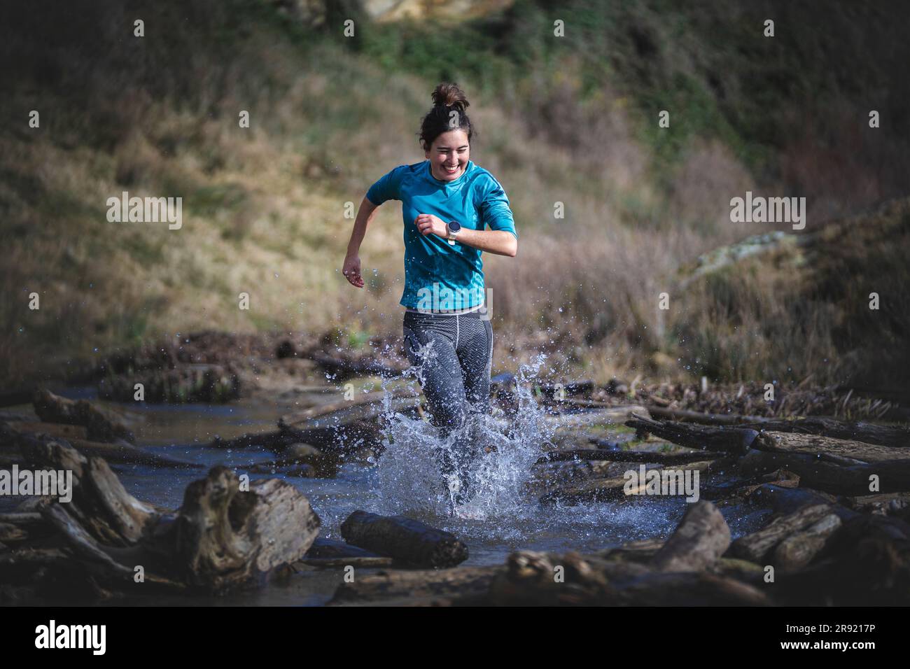 Woman splashing water running in sea Stock Photo