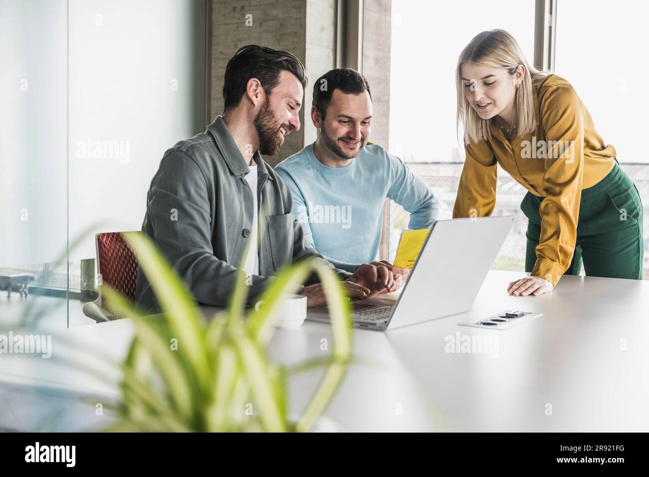 Smiling business colleagues working together at office Stock Photo