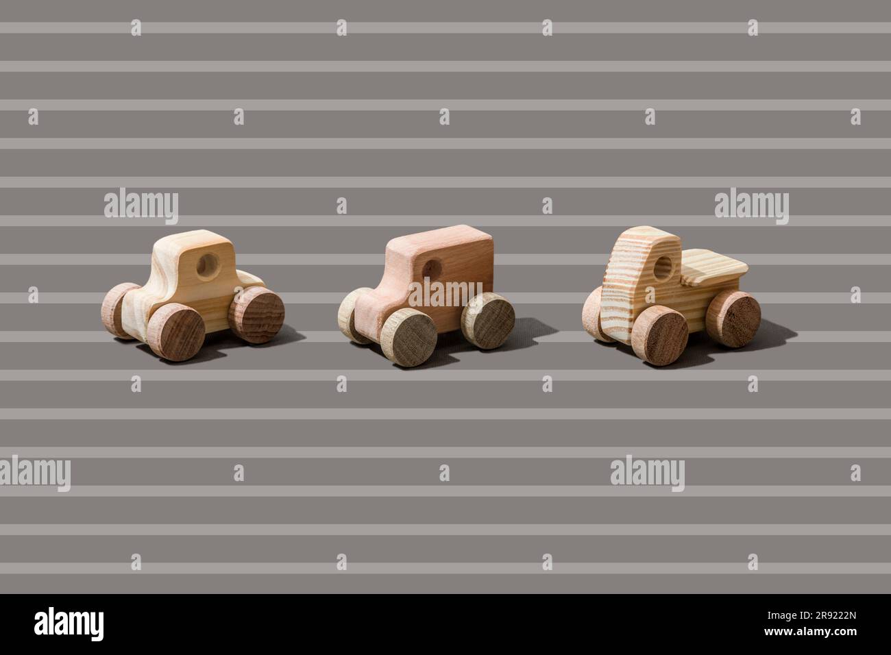 Wooden cars on stripped background Stock Photo