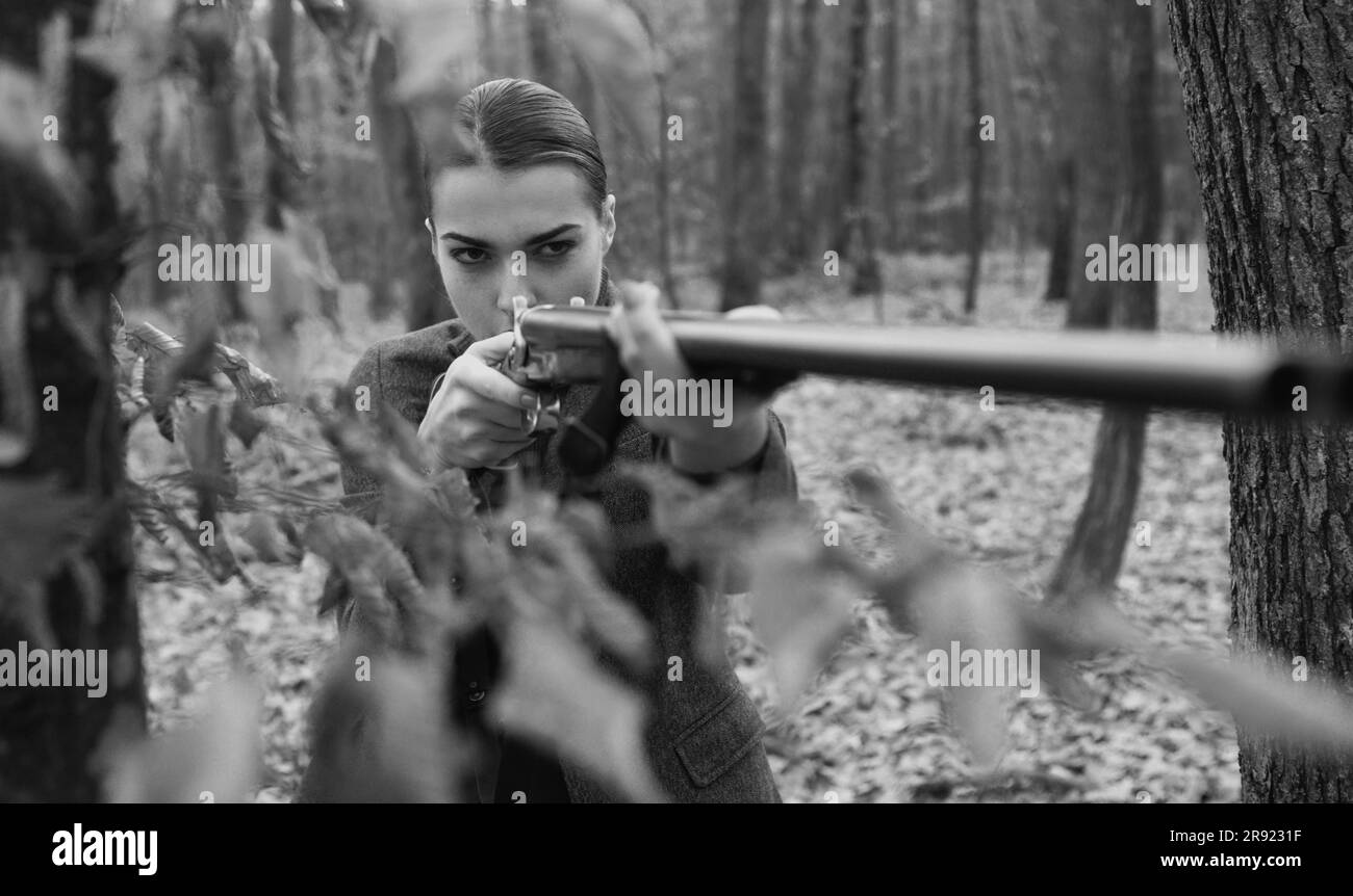 military fashion. gun barrel. achievements of goals. girl with rifle. chase hunting. Gun shop. female hunter in forest. successful hunt. hunting sport Stock Photo