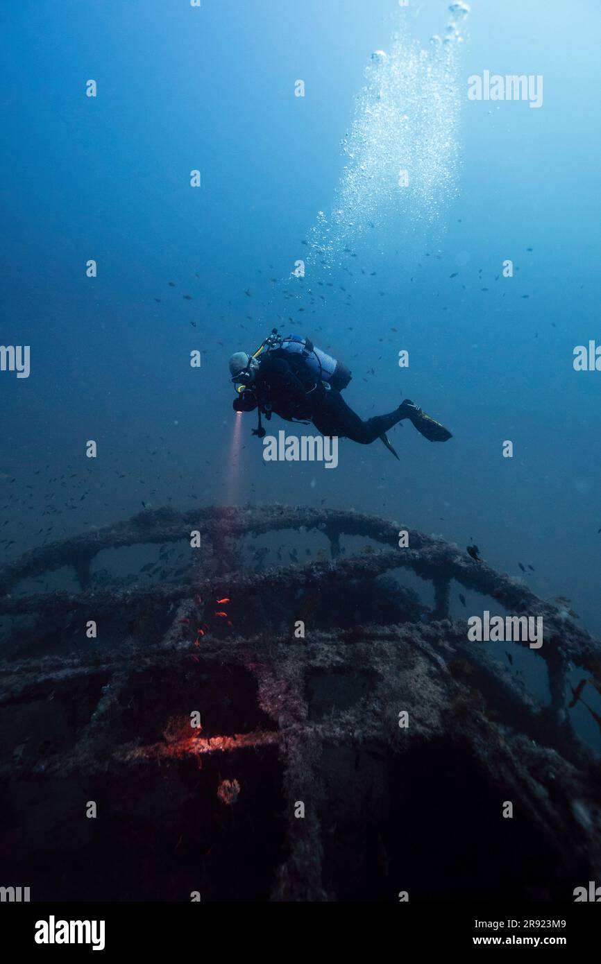 Man examining sunken ship El Naranjito undersea Stock Photo