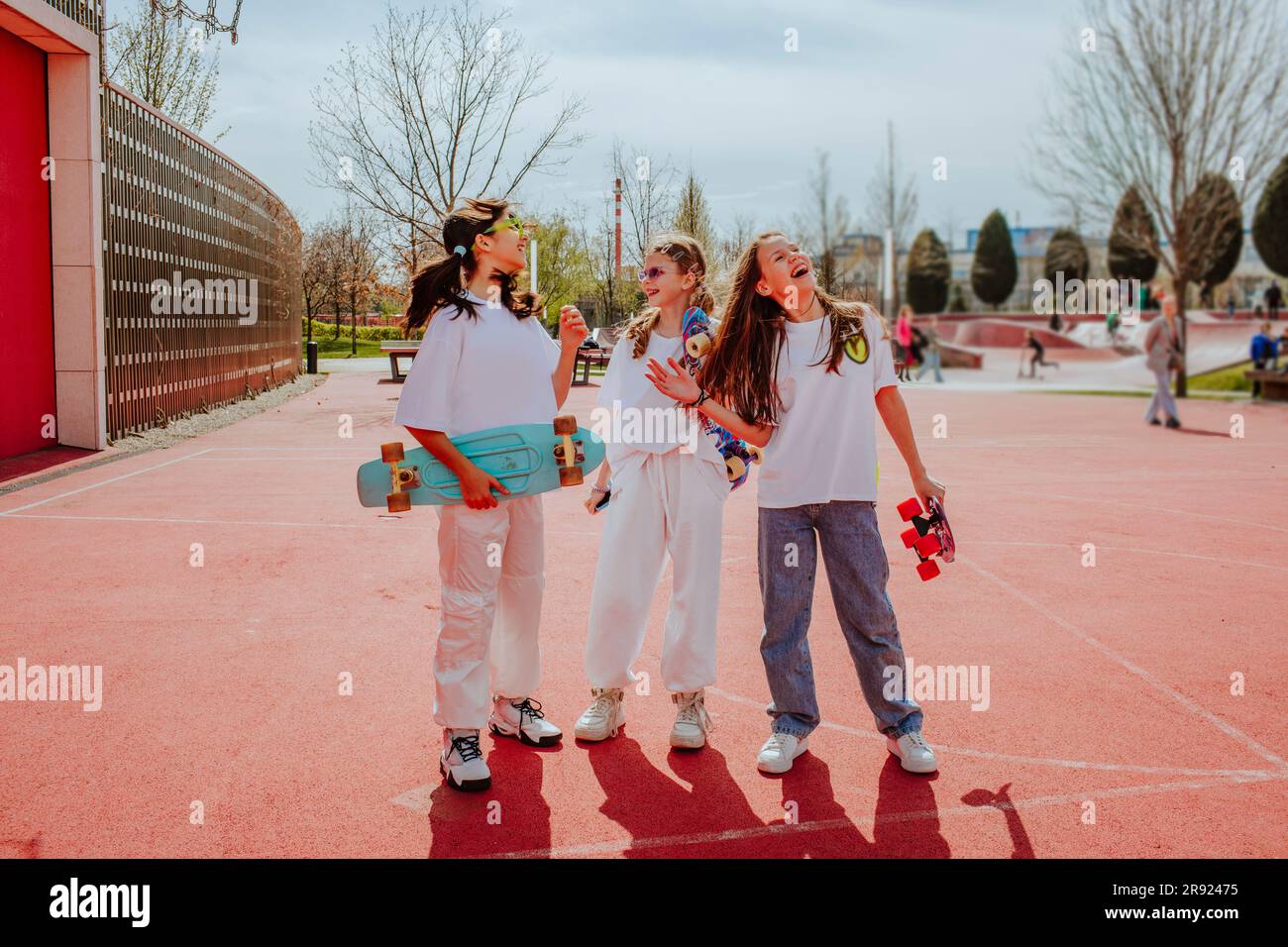 Teenage friends with skateboard spending leisure time at playground Stock Photo