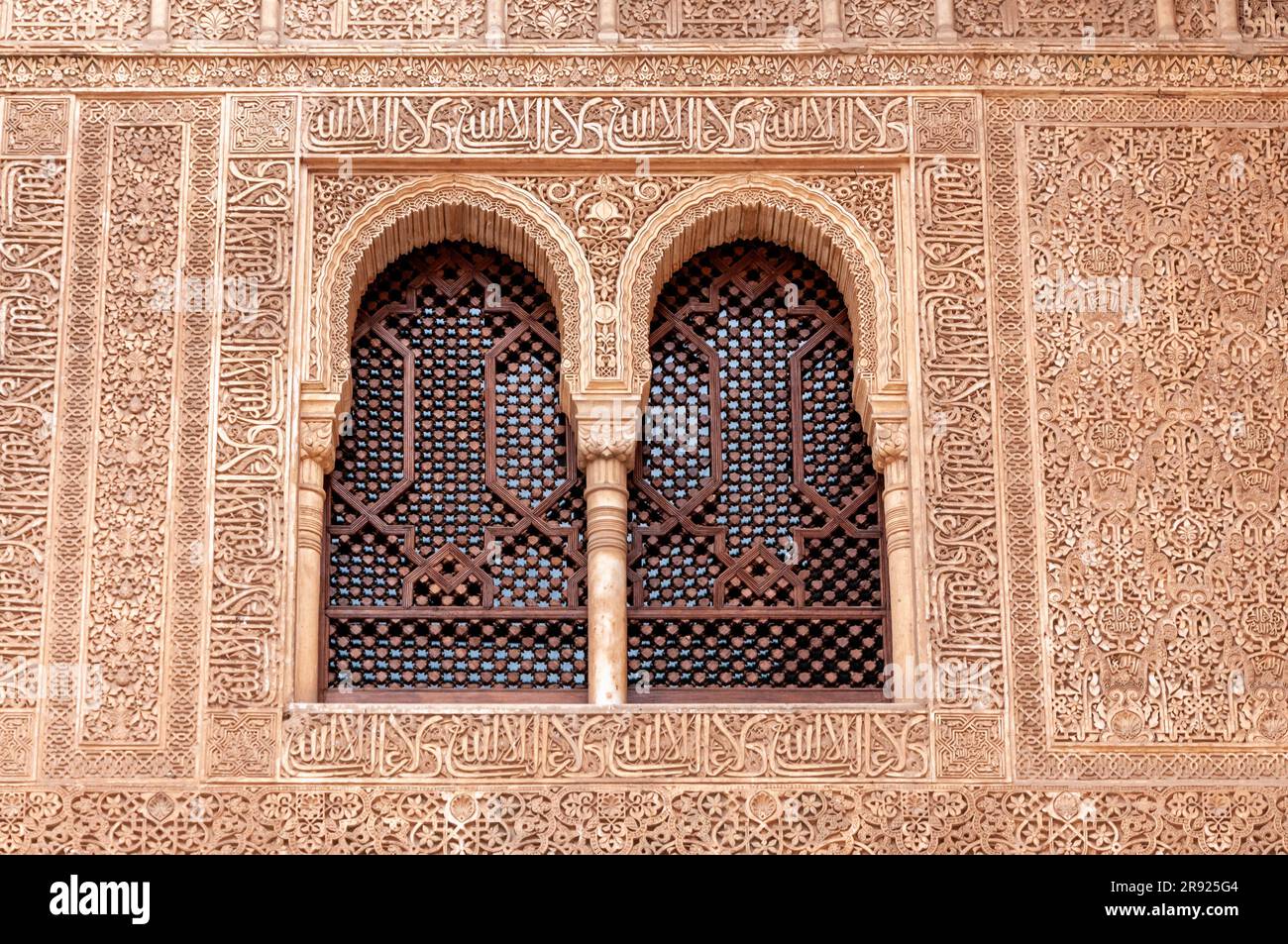 Islamic calligraphy on a window frame with floral designs Stock Photo