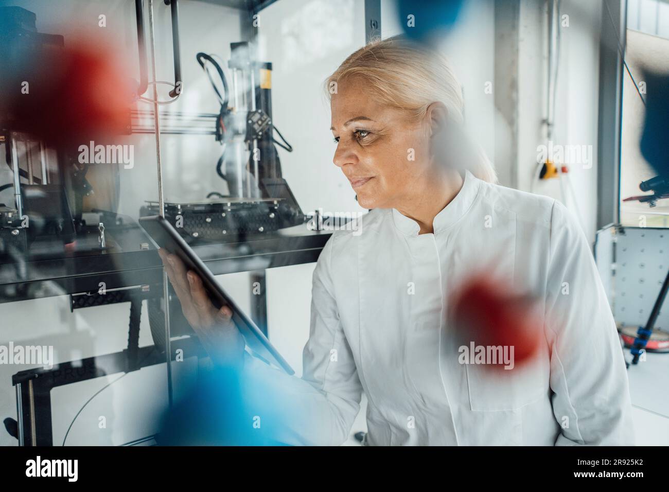Smiling scientist using tablet PC in laboratory Stock Photo