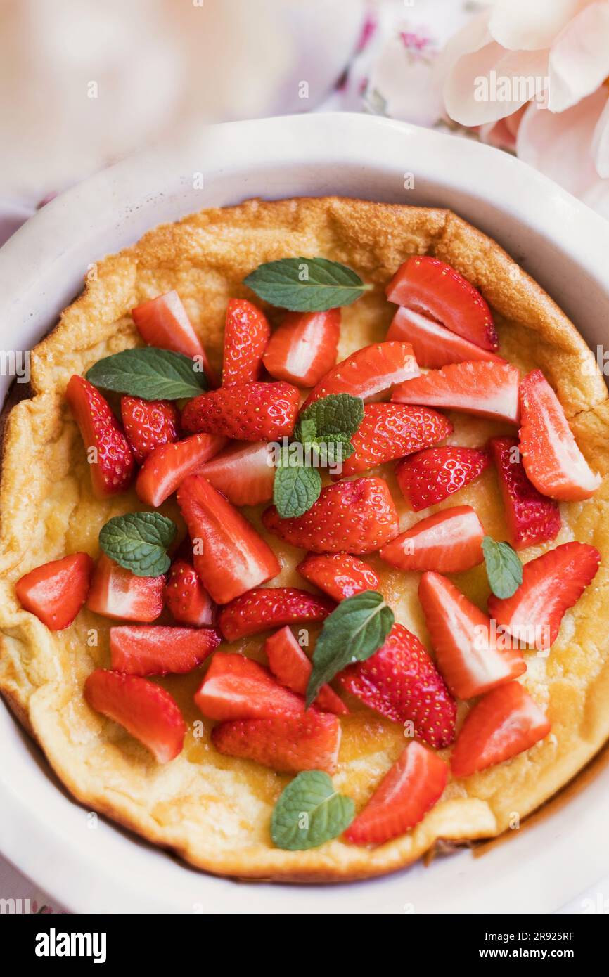 Dutch baby pancake with strawberries and mint Stock Photo