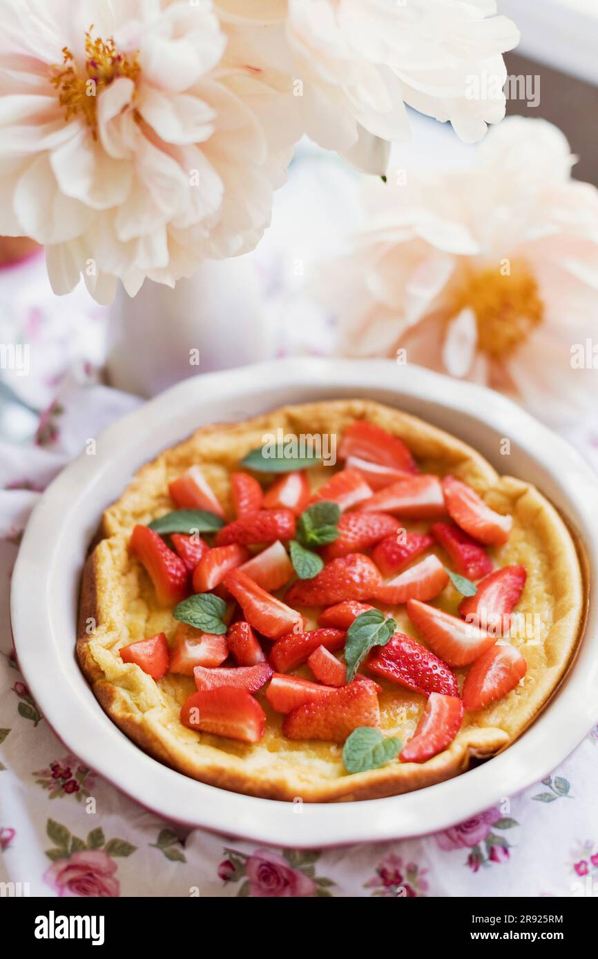 Dutch baby pancake with strawberries and mint Stock Photo