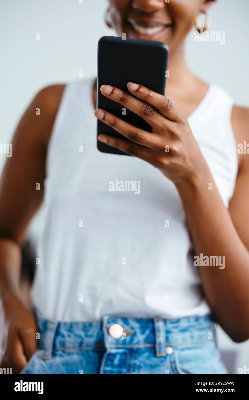 Freelancer surfing net through smart phone at office Stock Photo