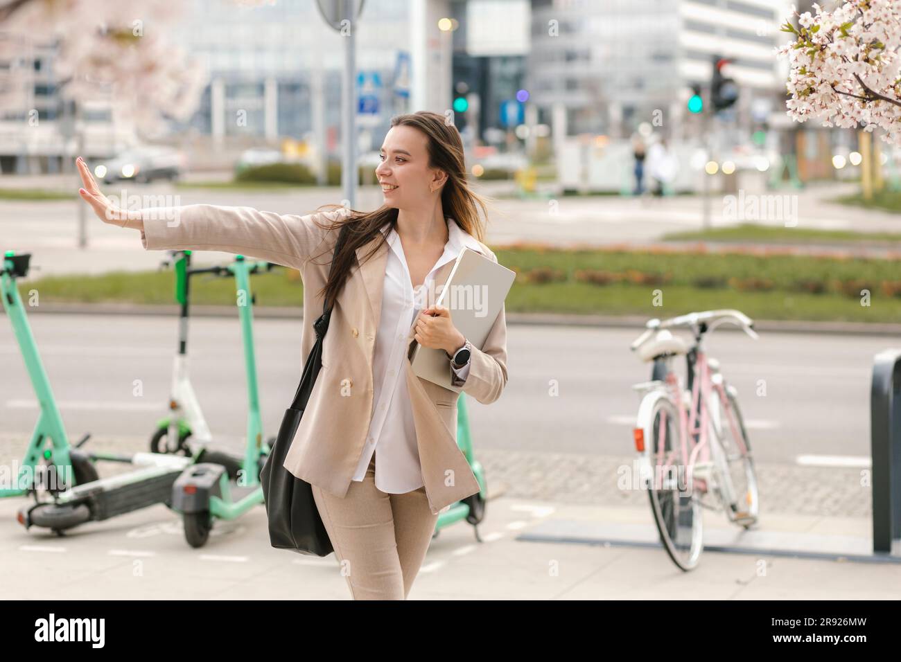 Smiling young businesswoman stop gesturing and crossing road Stock Photo