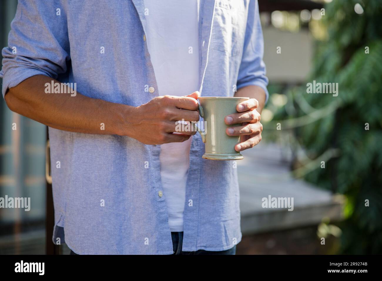 Young man standing with coffee cup Stock Photo
