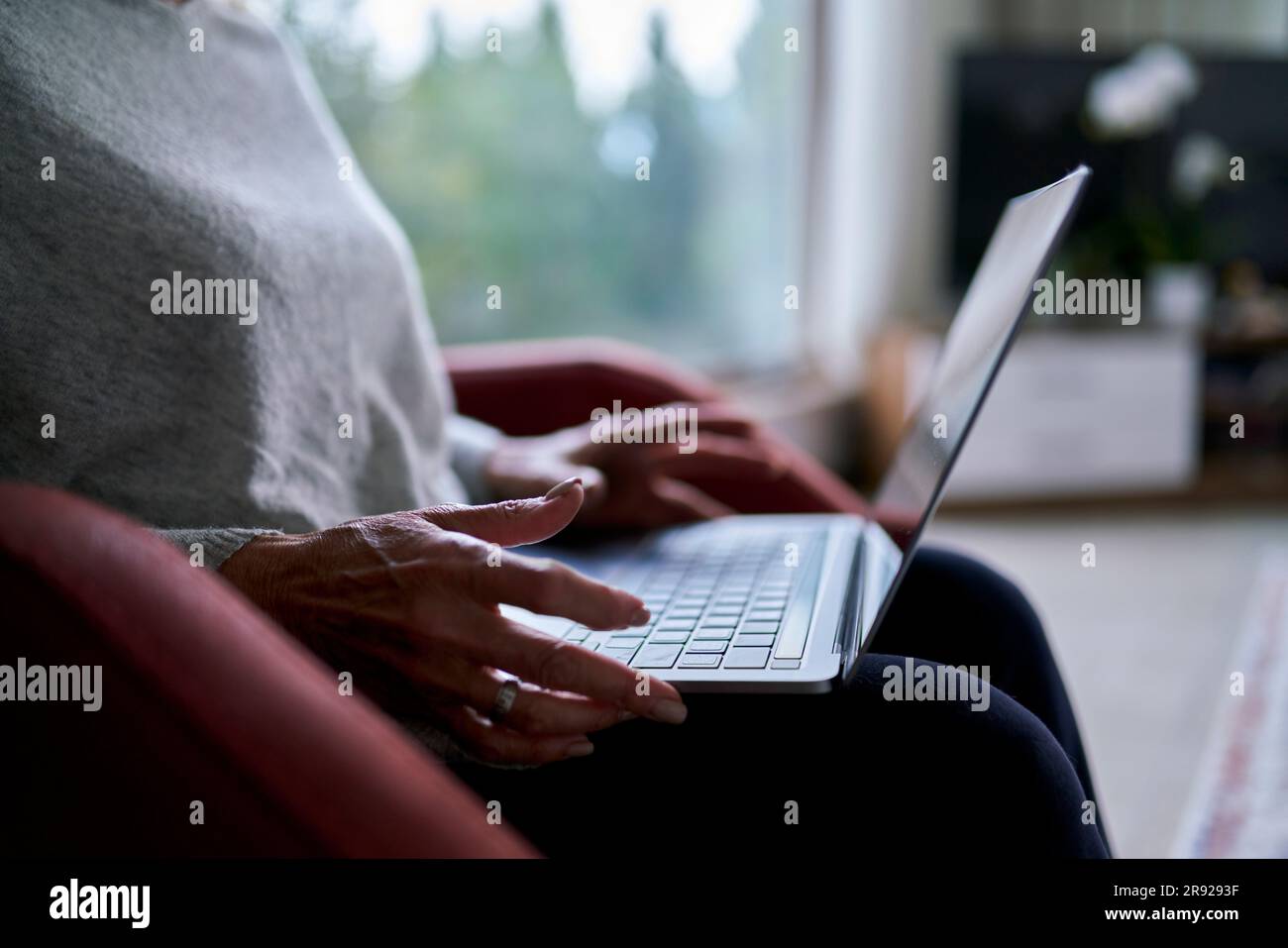 Senior woman using laptop at home Stock Photo