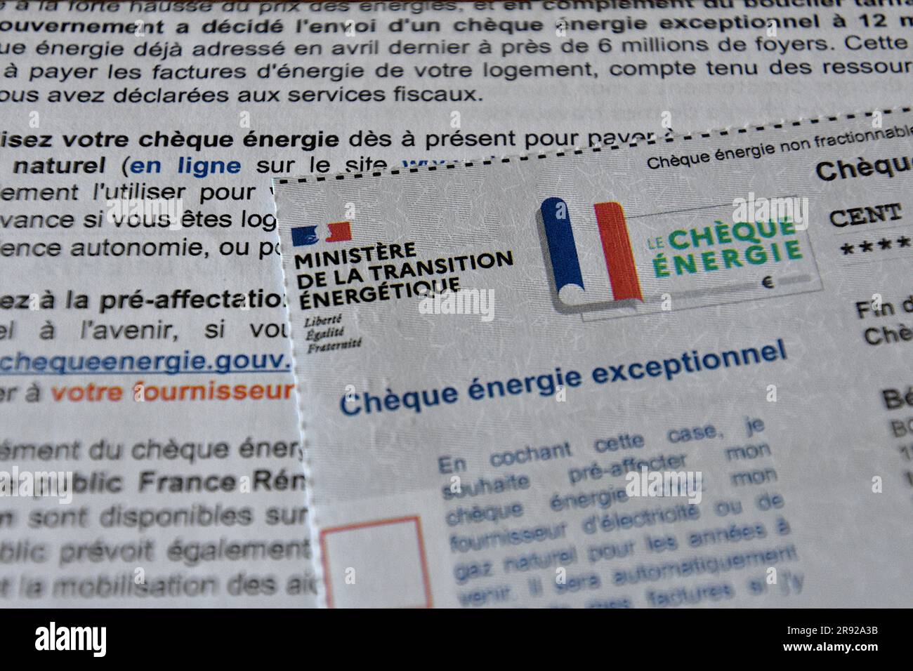 In this photo illustration, the documents concerning the energy check seen on display. To cope with soaring energy prices in French households, the French government has set up an energy check for the most modest households. Paid since April 21, 2023 and valid until March 31, 2024, the amount which varies between 48 and 277 euros, aims to support low-income households who are struggling to pay their electricity, gas, wood or of fuel oil. 5.8 million beneficiaries must receive this check according to a schedule that depends on their department of residence. Stock Photo