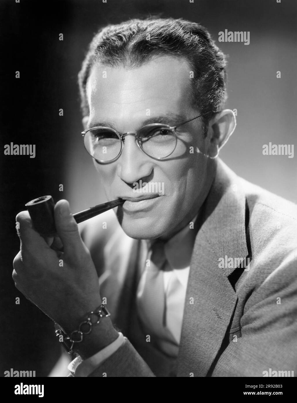 Ben Holmes (1890-1943) American Director and Screenwriter, head and shoulders portrait smoking a pipe, Unidentified Artist, 1936 Stock Photo