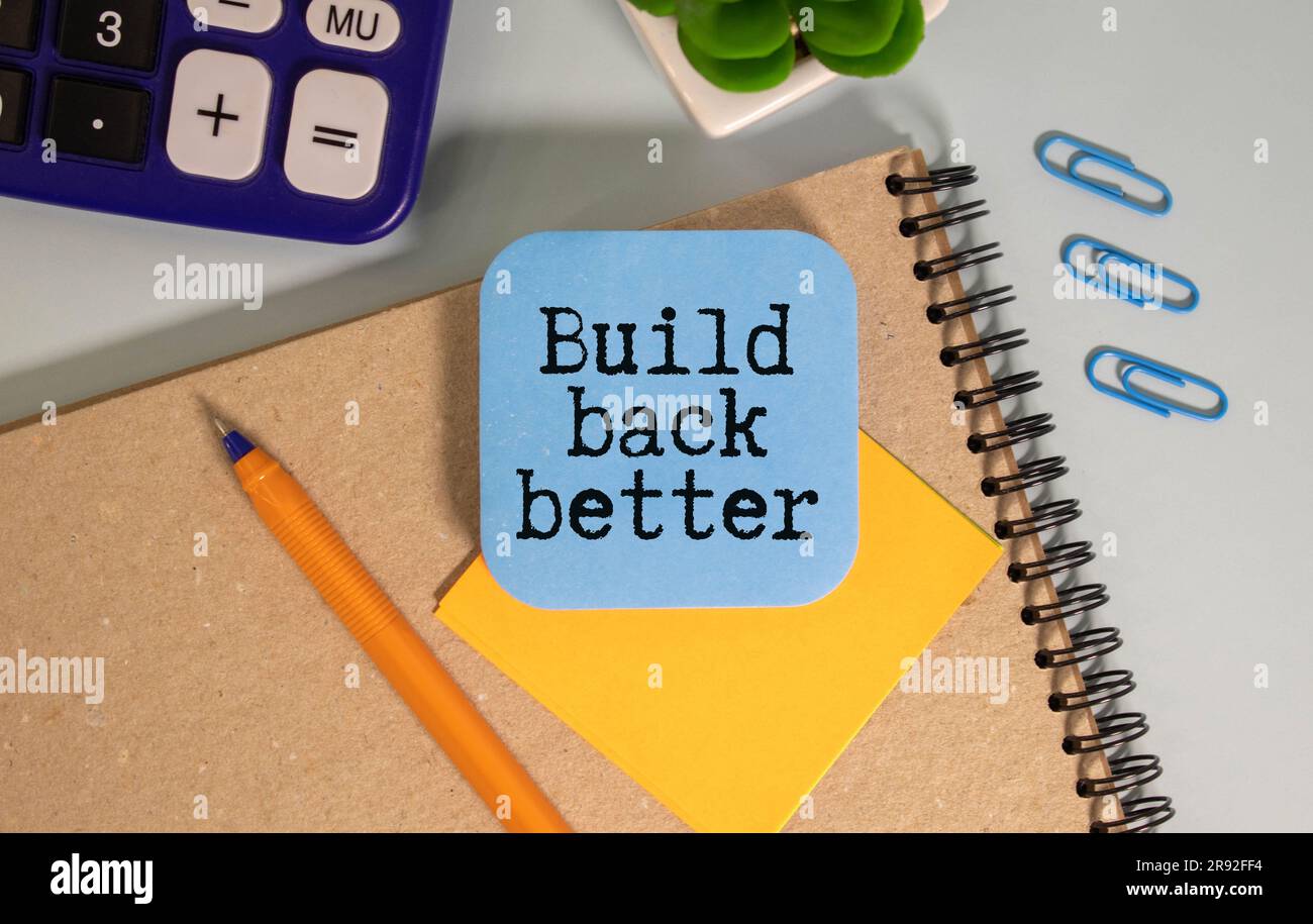 Build back better written in white chalk on a black chalkboard isolated on white. Stock Photo