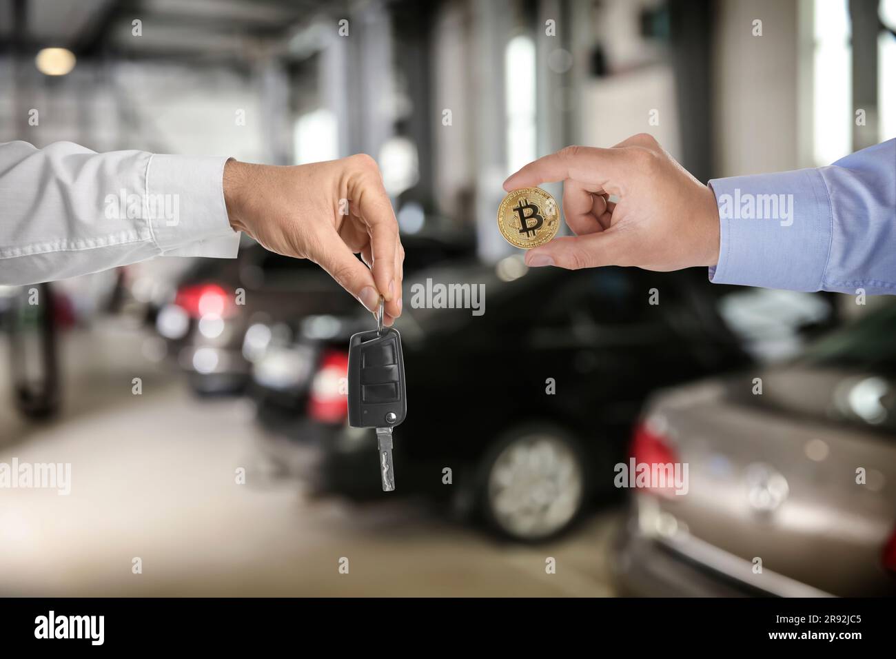Bitcoin exchange. Man using cryptocurrency to buy house. Seller holding key  and buyer with bitcoin indoors, closeup Stock Photo - Alamy