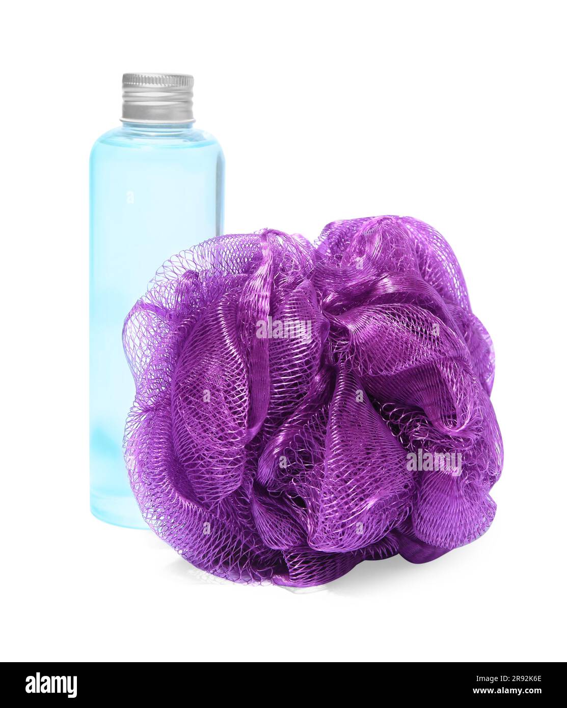 New purple shower puff and bottle of cosmetic product on white