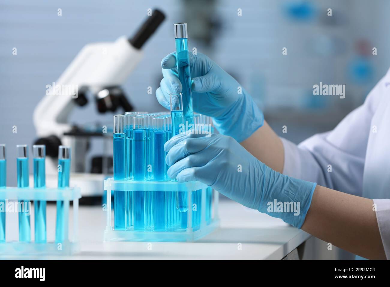 Samples In Lab Scientist taking samples from tubes hi-res stock photography and images ...