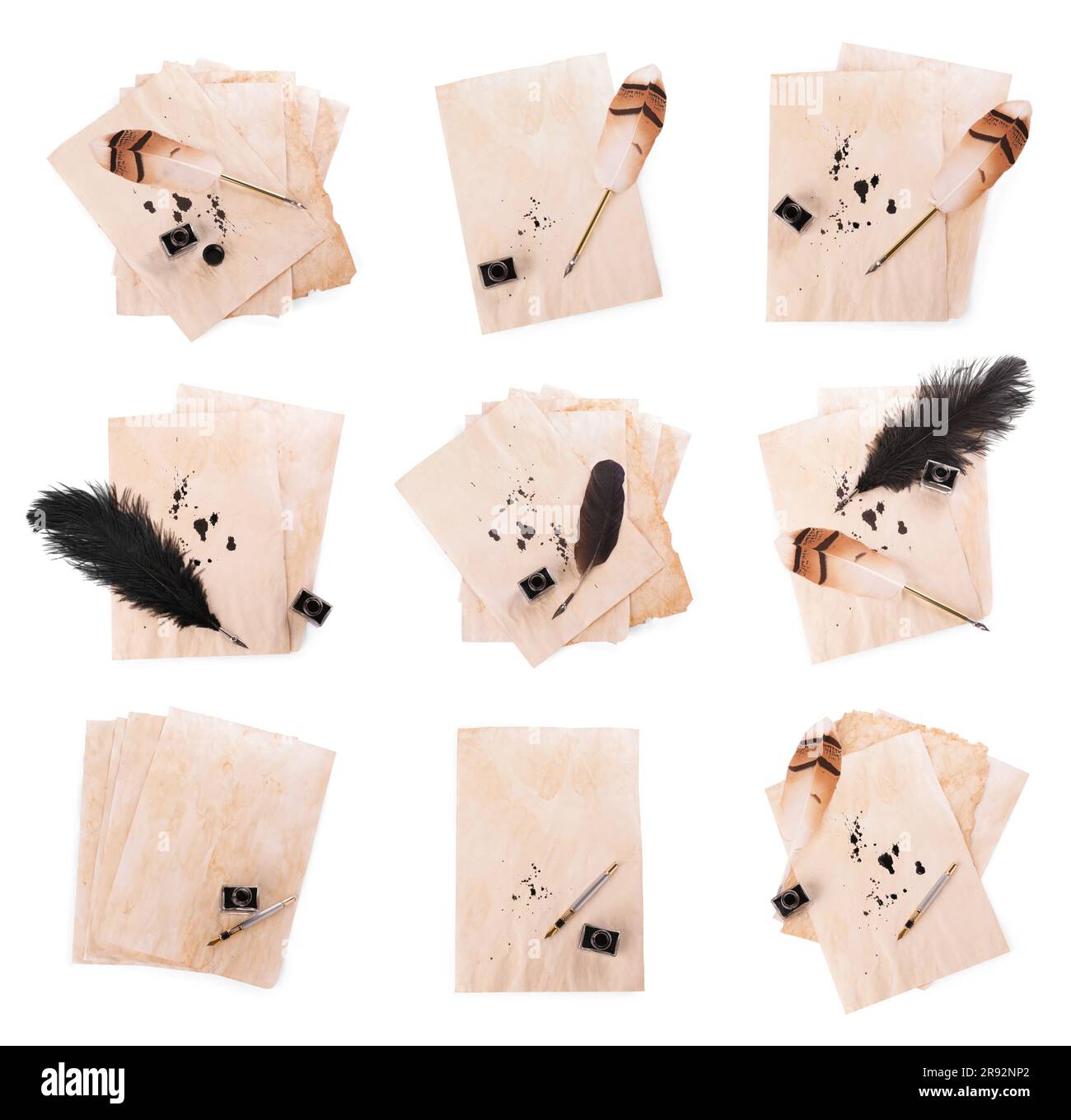 Many sheets of parchment, inkwell and different pens on white