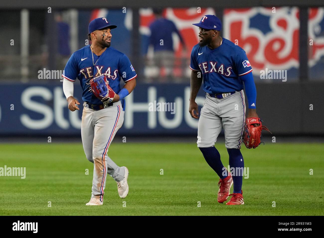 Texas Rangers right fielder Adolis Garcia (53) and left fielder Ezequiel  Duran (20) celebrate after closing the tenth inning of a baseball game  against the New York Yankees, Friday, June 23, 2023