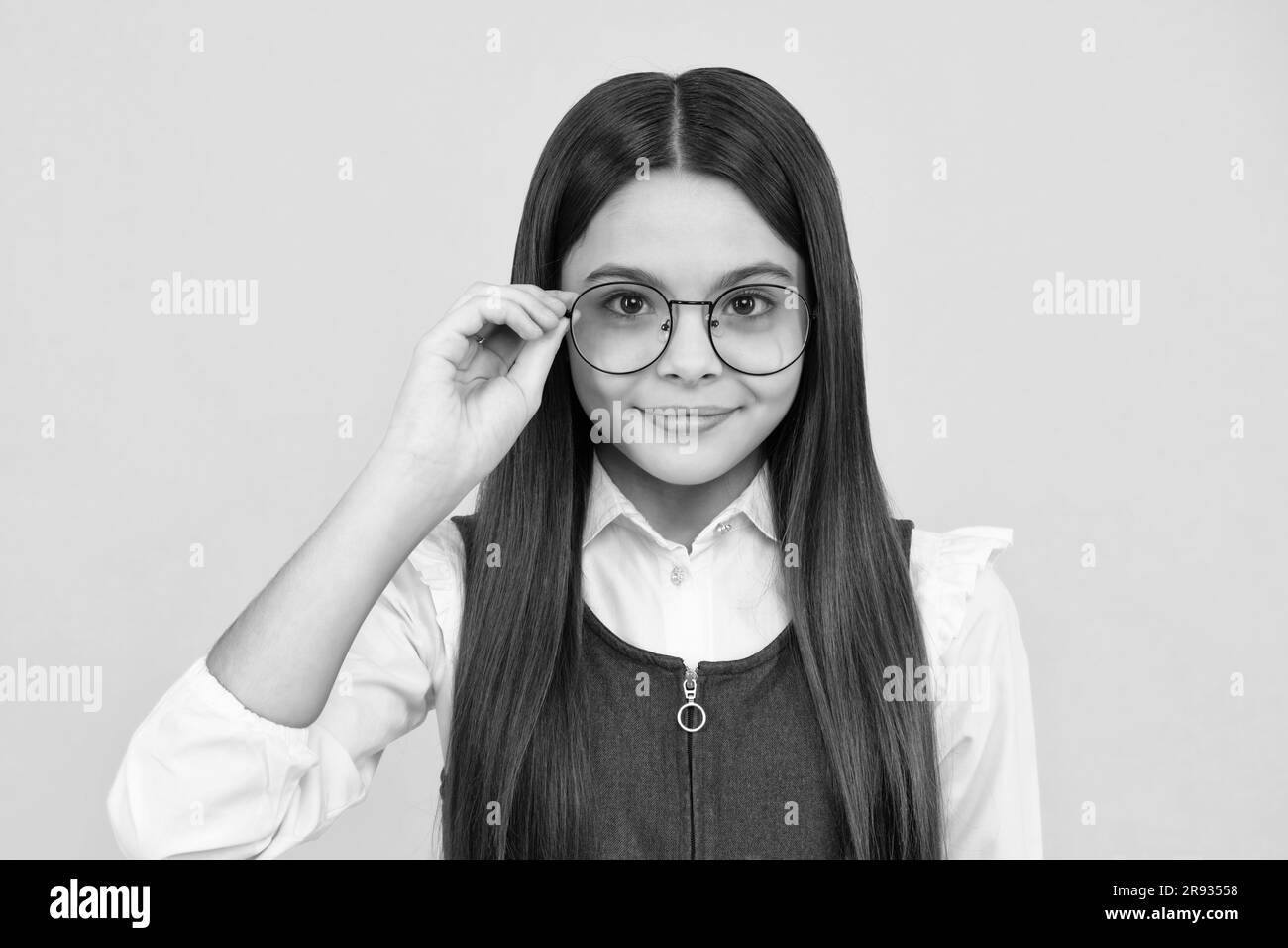 Headshot portrait of cute teenager child girl isolated on yellow studio