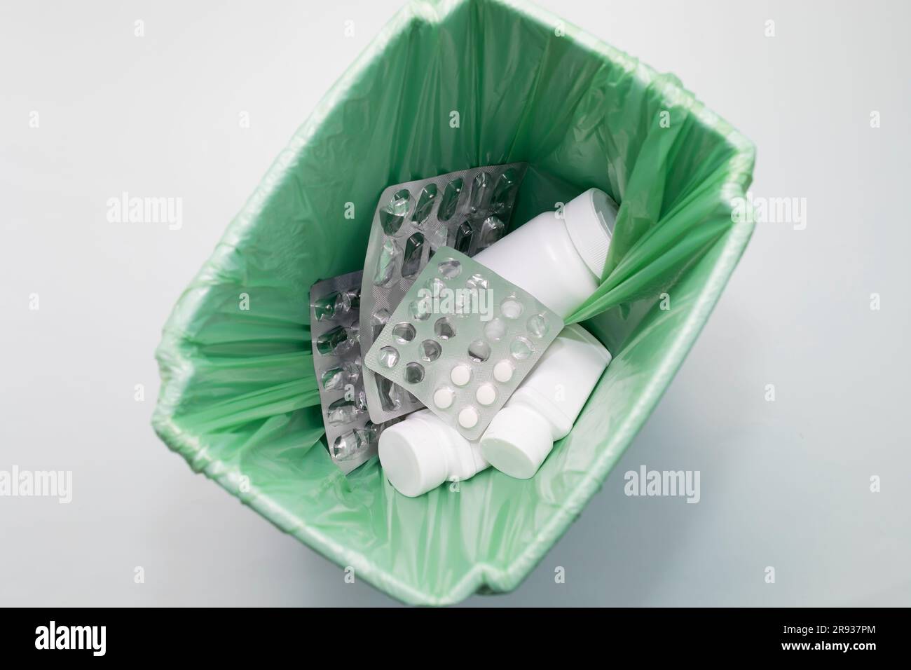 https://c8.alamy.com/comp/2R937PM/top-view-medication-supplement-pills-tablet-bottles-empty-capsule-pastilles-in-trash-bin-bucket-medical-waste-drug-consumption-concept-2R937PM.jpg