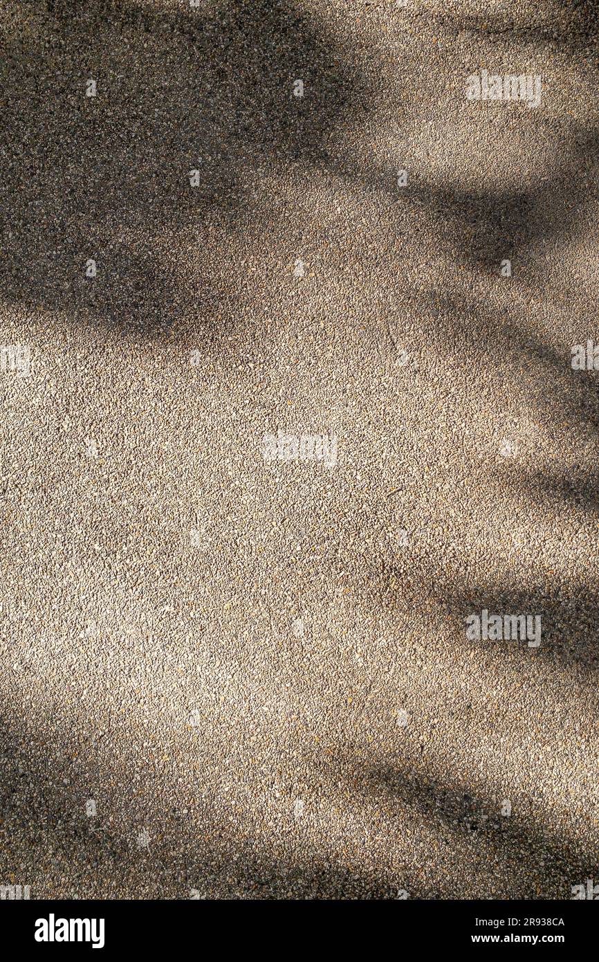 exposed aggregate finish texture background with sunlight shade Stock Photo