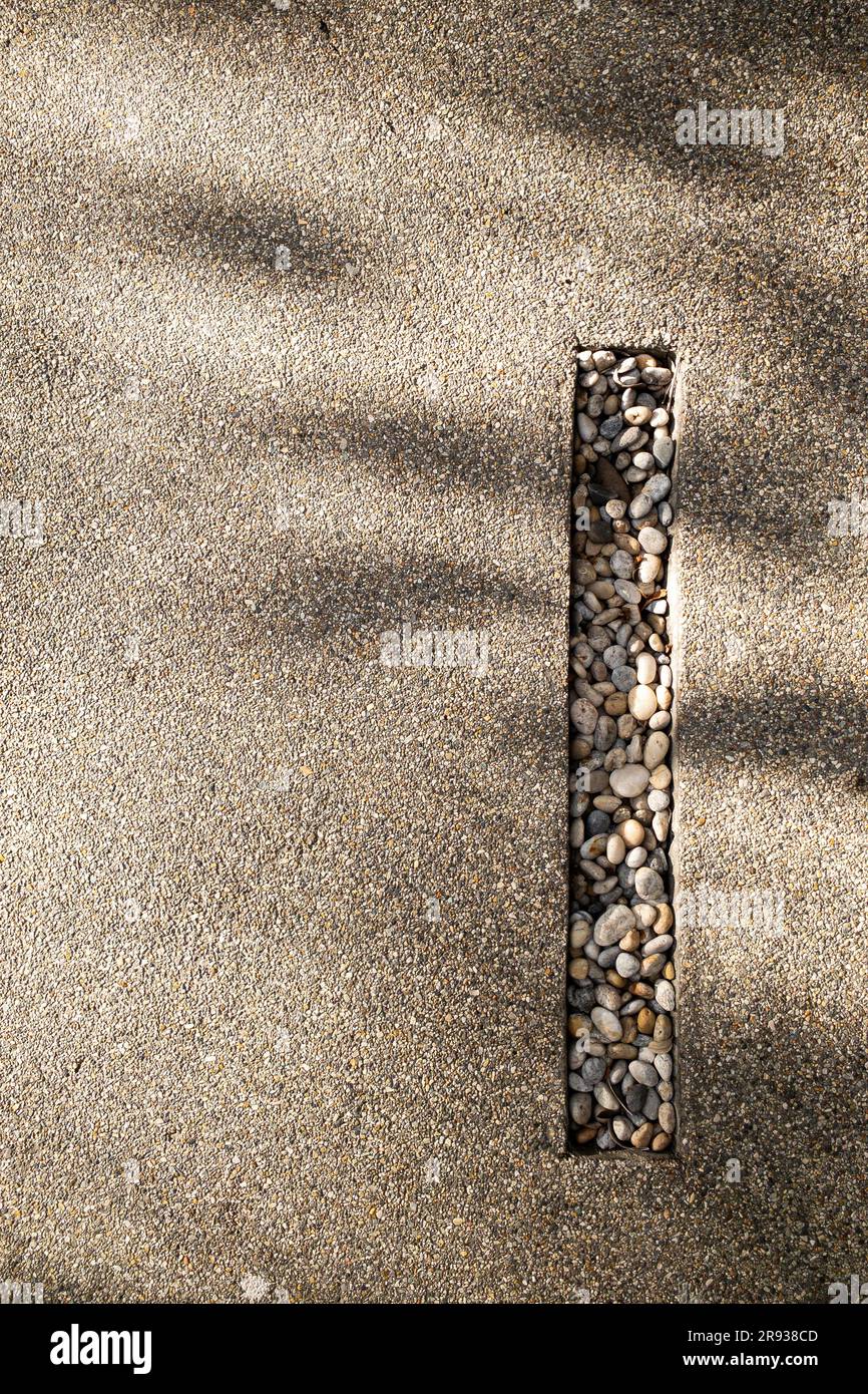 exposed aggregate finish texture background with sunlight shade Stock Photo
