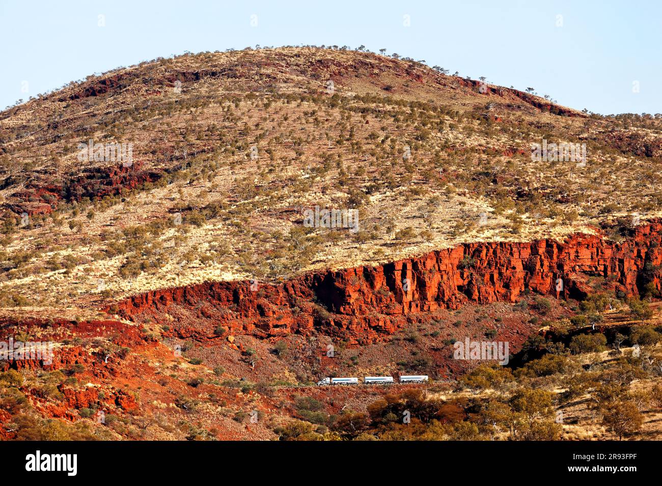 Road train truck dwarfed by the Munjina Gorge landscape, Pilbara,  Western Australia Stock Photo