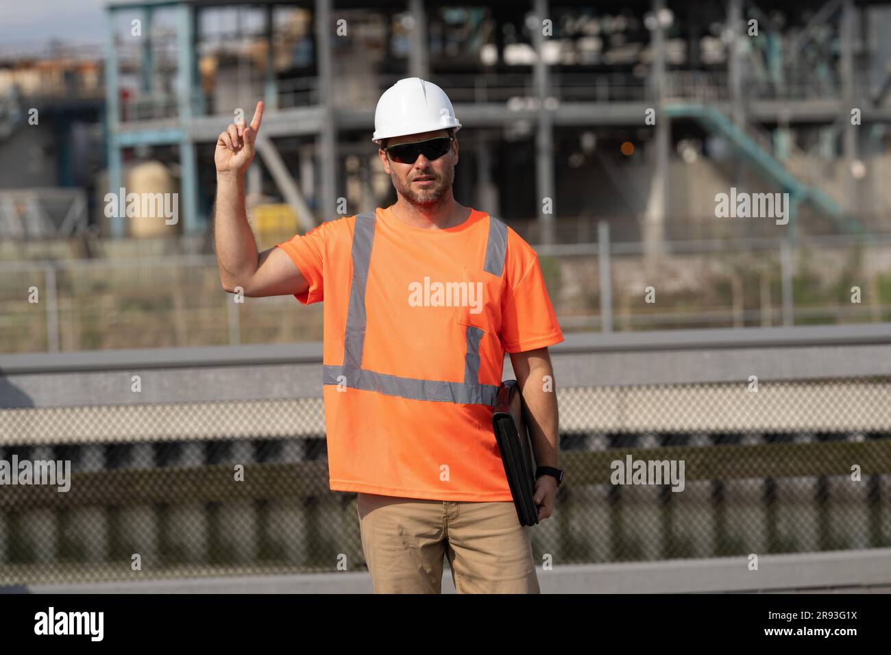engineer man at construction site with raised finger wearing hardhat ...