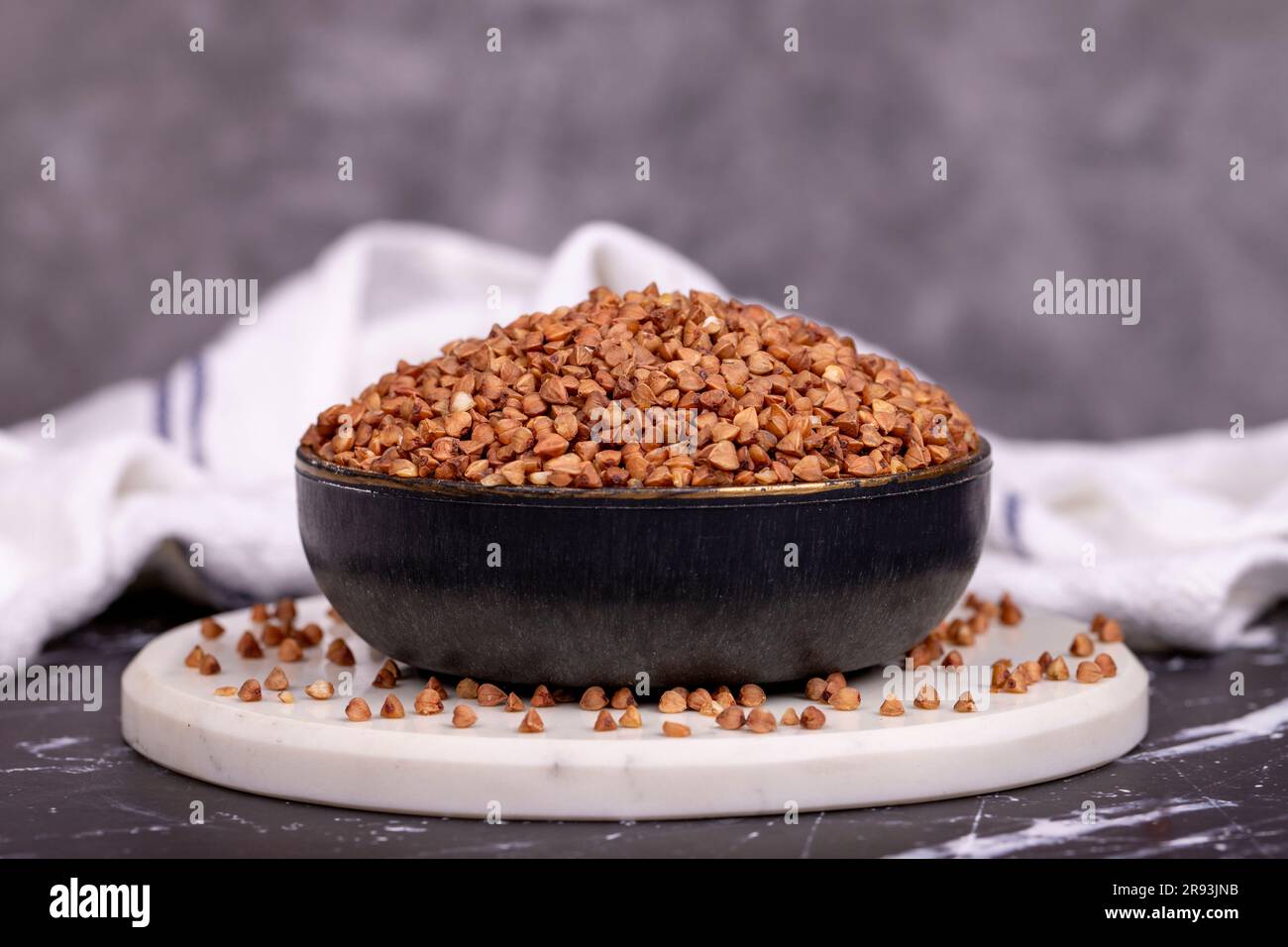 Buckwheat on dark background. Buckwheat grains in bowl Stock Photo