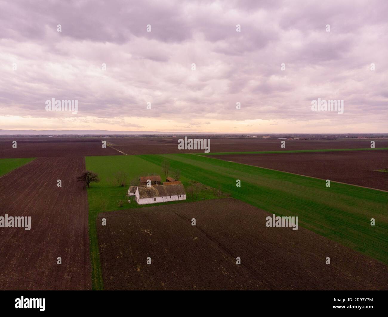 Aerial flight over Winter Agricultural fields with abandoned ranch ...
